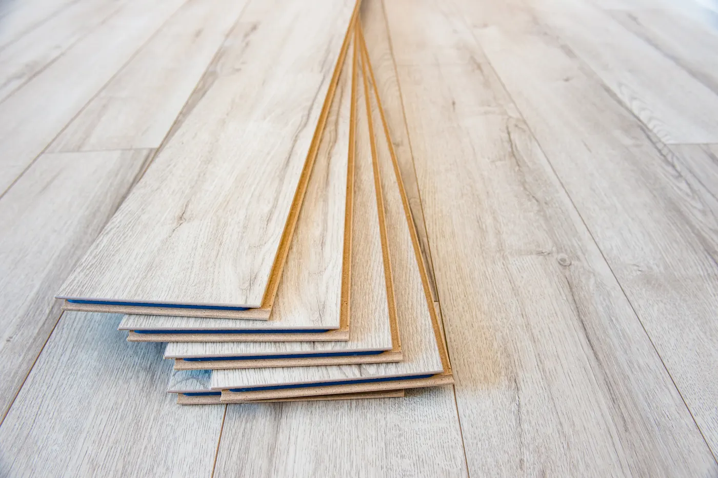 Vinyl plank flooring fanned out over a newly laid floor