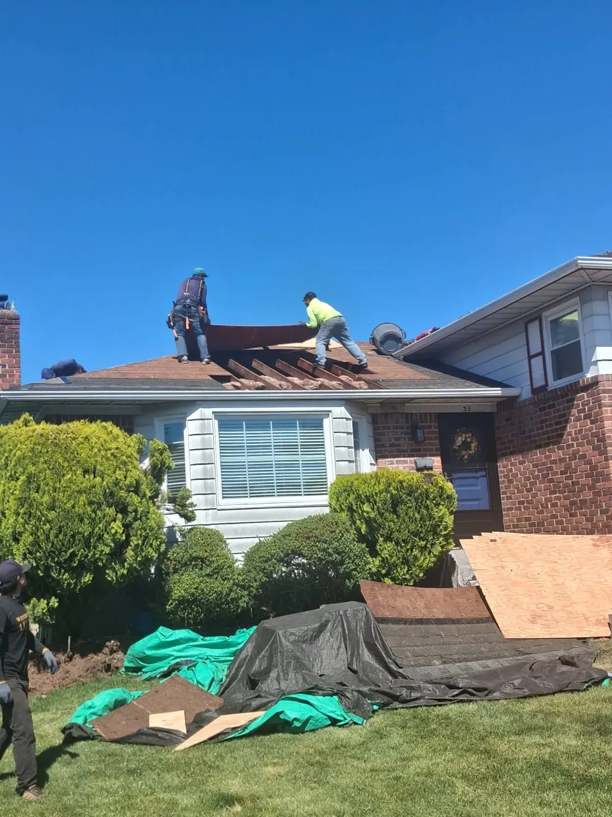 Our crew laying new roof sheathing on a Long Island home